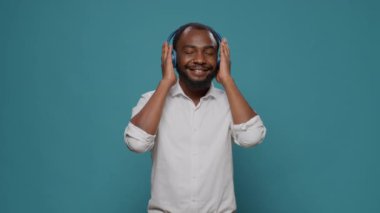 Gülümseyen yetişkin, mp3 radyo müziği dinlemek için kulaklık kullanıyor.