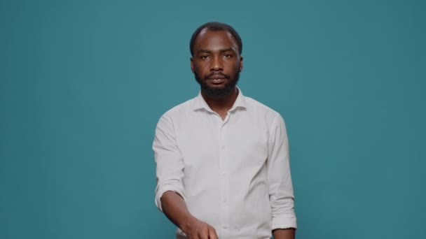 Portrait of male model showing silence sign in front of camera — Stock Video