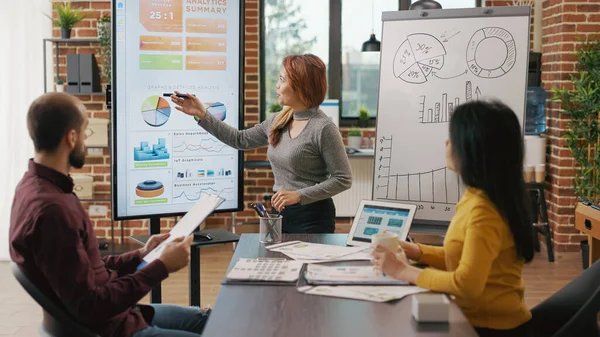 Business people looking at briefing presentation on display — Stockfoto