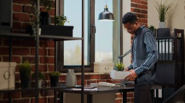 Stresli bir adamın işten kovulması ve ofis eşyalarını toplaması.