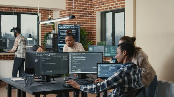 Programmer analyzing compiling code on multiple screens takes off glasses and doing high five hand gesture — Stockfoto