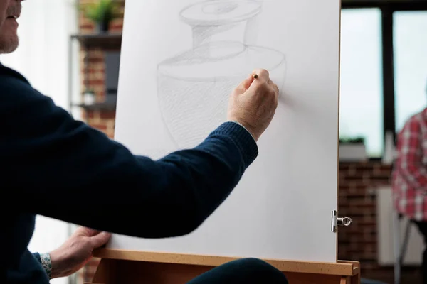 Close up de pintor homem sênior desenho vaso esboço na tela branca — Fotografia de Stock