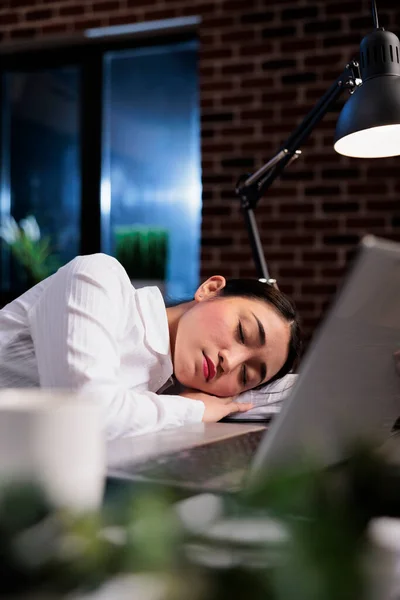 残業後のオフィスワークスペースで机の上で寝ている疲れた実業家の肖像画. — ストック写真