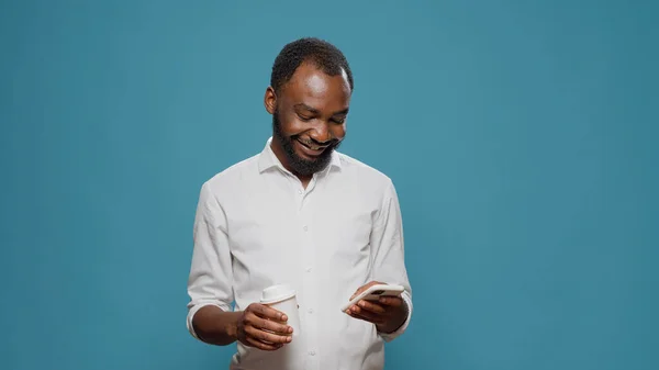 アフリカ系アメリカ人男性がスマートフォンでインターネットを閲覧 — ストック写真