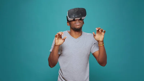 Modern adult having fun with vr glasses game on camera — Stock Photo, Image