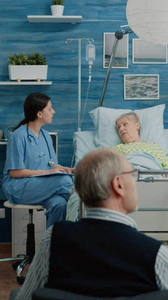 Medical nurse consulting senior woman about treatment — Stock Photo, Image