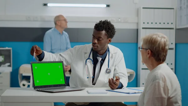 Ung läkare med bärbar dator med grön skärm teknik — Stockfoto