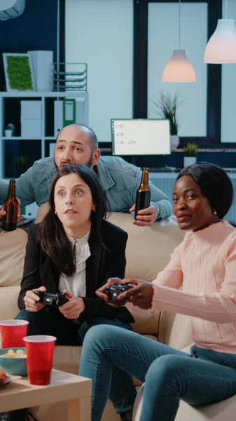 Colleagues playing video games on console with controller — Stock Photo, Image
