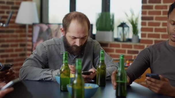 Young man hanging out with friends and browsing internet — Stock Video