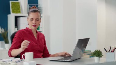 Office worker planning sales statistics report on laptop