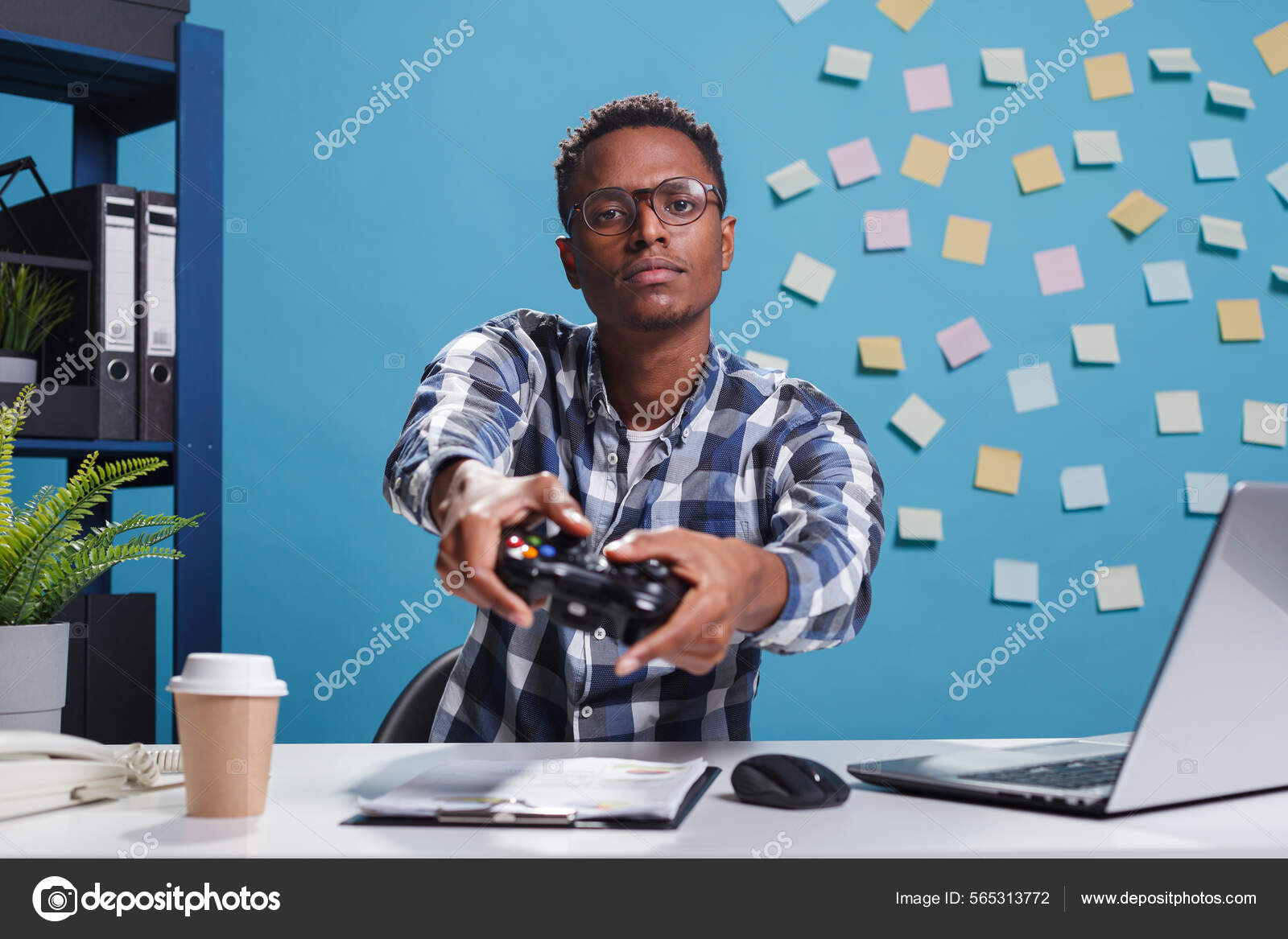 Person playing video games with controller on computer Stock Photo