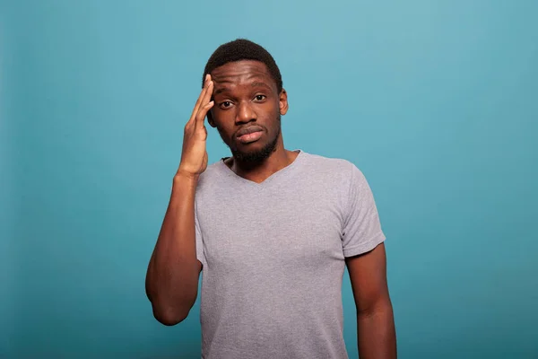 Stressed man dealing with headache and rubbing temples — Foto de Stock