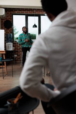 Sanat dersine katılan çeşitli öğrenciler çizim tekniği öğreniyor.