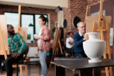 Resim çizim sınıfını denetleyen sanatçı öğretmen çizim tekniğini açıklıyor