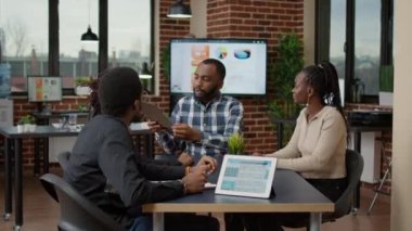 Afro-Amerikan iş adamlarından oluşan bir ekip finansal haritaları inceliyor.