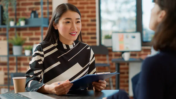 Female recruiter interviewing woman with work experience on cv