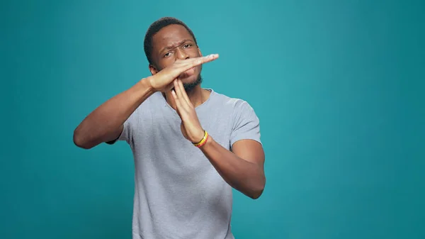 Serious tired person advertising timeout symbol with hands — Stock Photo, Image