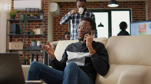 African american person chatting on phone call in business office —  Fotos de Stock