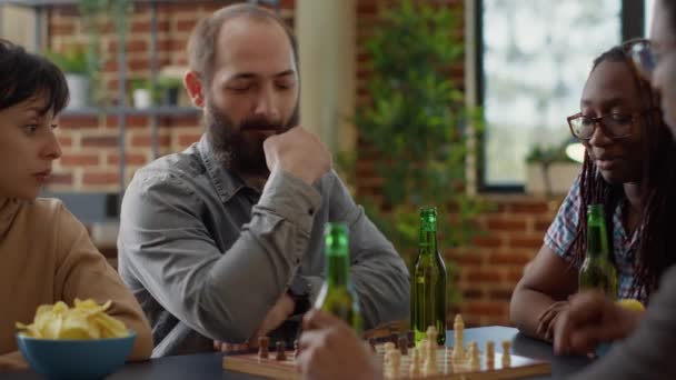 Diverse group of friends having fun with chess board games — Stockvideo