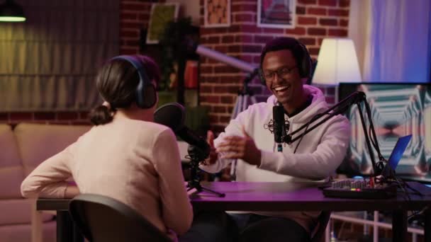 African american podcaster introducing famous influencer to listeners in evening online show — Stock videók