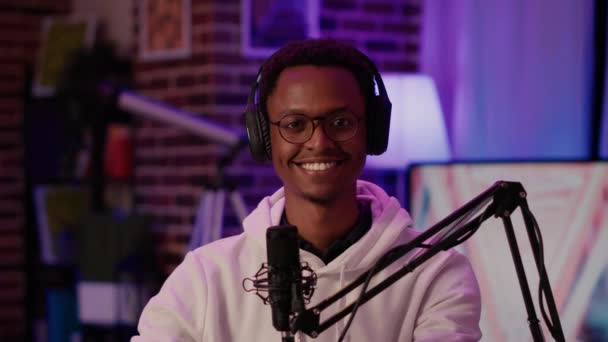 Portrait of african american podcaster smiling confident at camera while recording podcast — Stok video