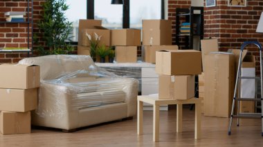 No people in empty living room apartment with carton boxes