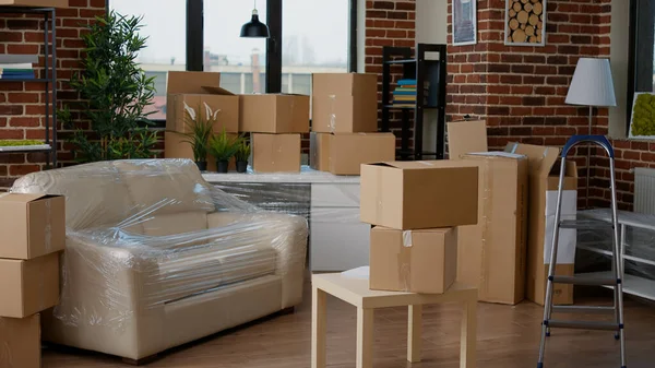 Empty apartment flat full of moving unpacked cardboard boxes