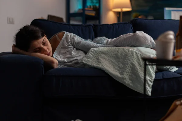 Sad depressed woman with anxiety laying on sofa in solitude — Photo