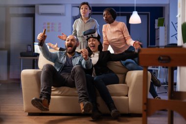 Cheerful colleagues winning video games play with vr glasses