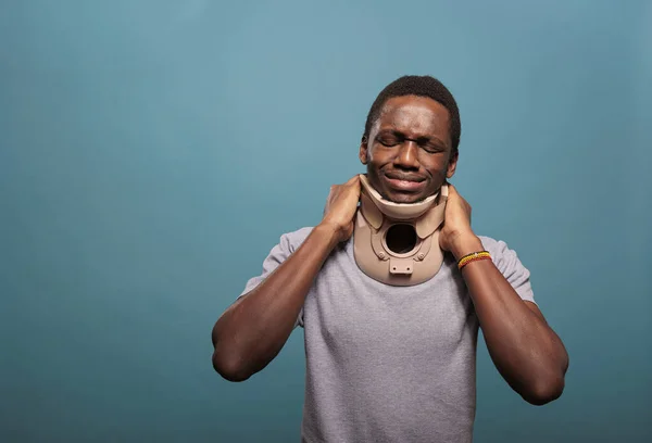 Emotional guy wearing cervical collar to cure physical injury — Foto de Stock