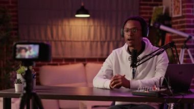 Afro-amerikan içerik yaratıcısı dijital kamerayla video bloğu kaydediyor ve şovunu izlediğiniz için teşekkür ediyor.
