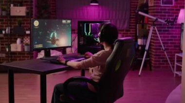 Gamer girl feeling shouting at computer screen after losing difficult level in online space shooter