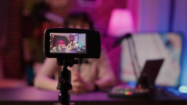 Selective focus on digital video camera screen recording content creator streaming live internet radio — Stok Video