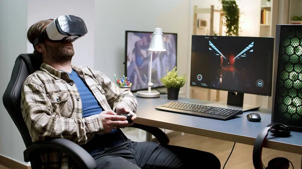 Bearded man sitting on gaming chair playing games