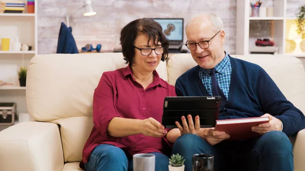 Oudere echtpaar zwaaiend naar tablet tijdens een videogesprek — Stockfoto