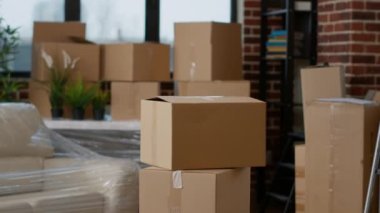 Nobody in living room flat full of cardboard carton boxes