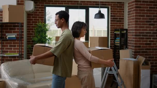 Portrait of multiethnic couple moving in rented flat together — Video Stock