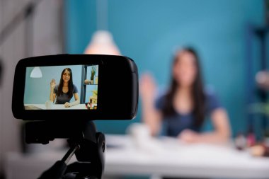Behind the scene of woman vlogger greeting remote subscribes