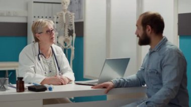 Medical specialist having conversation with patient at appointment