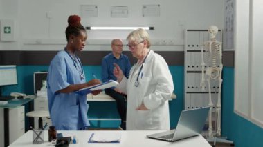 Çeşitli tıp uzmanları sağlık teşhisini tartışıyor.