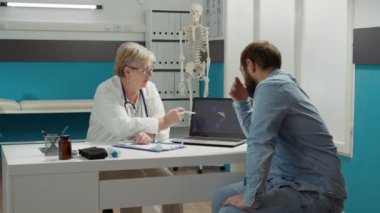 Health specialist showing coronavirus illustration on laptop