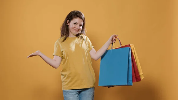 Portrait of woman feeling proud of purchase showing excitement for buying products — Stok fotoğraf