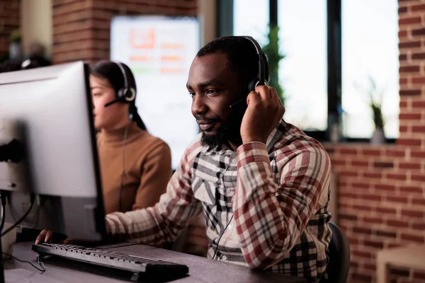 African american call center operator talking to clients on helpline — Foto de Stock