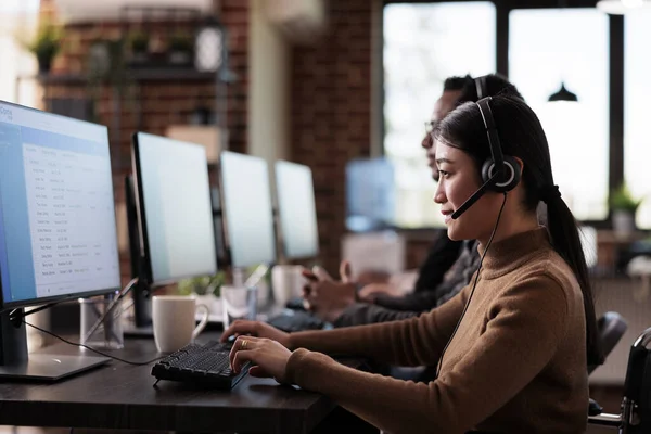 Paralyzed asian employee working at call center reception