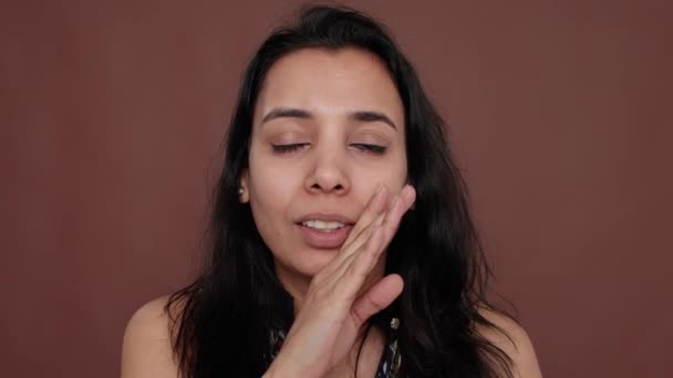 Portrait of indian woman sharing overheard secret in studio — Video