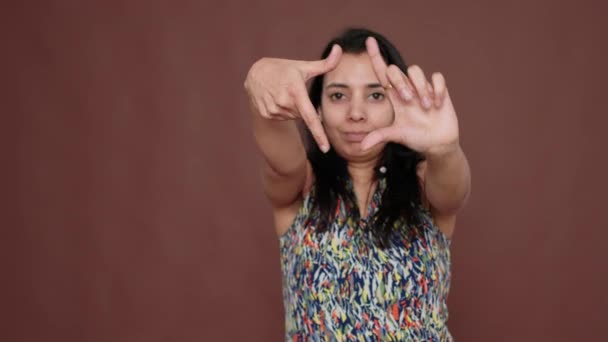 Creative indian model pretending to take picture in studio — Vídeo de stock