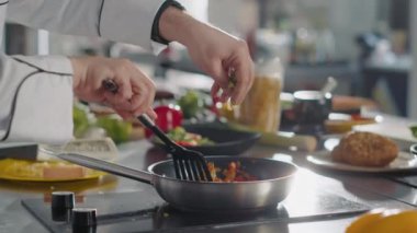 Gourmet chef preparing fresh vegetables in organic olive oil