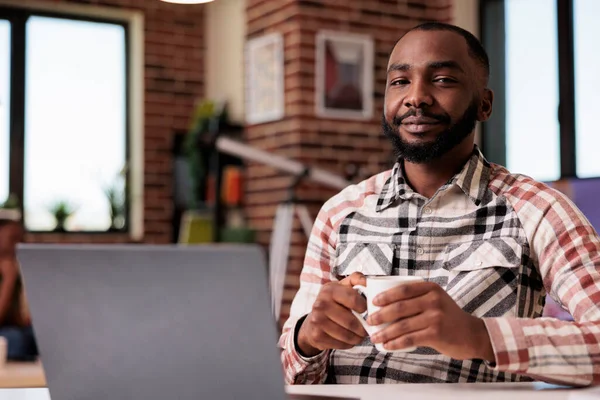 Portrait of confident freelance programmer looking at camera taking a break from coding — Stock Photo, Image