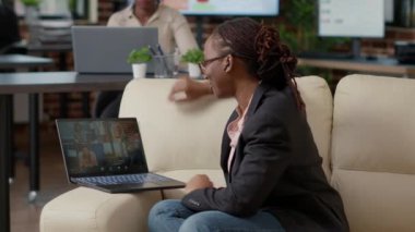 Female worker attending business meeting on videocall