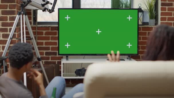Modern group of people looking at green screen on television — Stockvideo